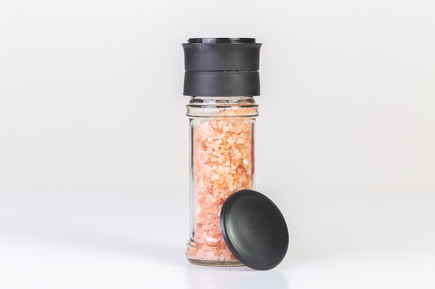 Himalayan salt crystals in a glass grinder.