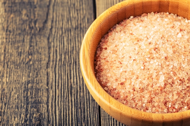 Himalayan salt on old wooden table.