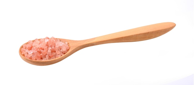 Himalayan salt in the spoon on white background