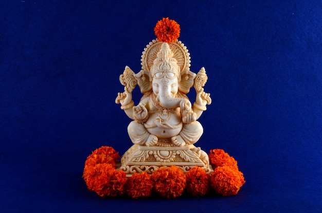 Hindu God Ganesha. Ganesha Idol on blue space