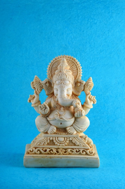 Hindu God Ganesha Idol on blue surface