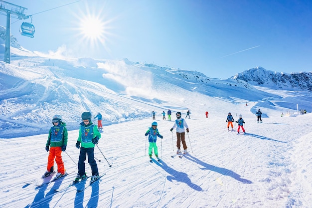 Hintertux, Austria - February 5, 2019:  Group of Children Skiers with instructor skiing in Hintertux Glacier in Tyrol, Mayrhofen, winter Alps. Kids and woman Ski at Hintertuxer Gletscher in mountains