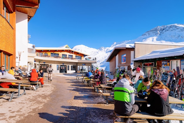 Hintertux, Austria - February 5, 2019: People relaxing in restaurant with cafe chalet house on Hintertuxer Gletscher ski resort in Tyrol in winter Alps. Hintertux glacier at Alpine mountains