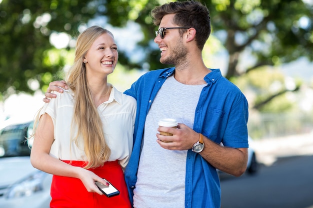 Hip couple laughing together in the city