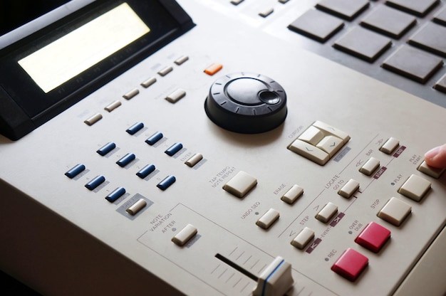 A hip hop composer beatmaker creates beats on a digital production controller with pushbutton pads The DJ plays the beats live on the pad controller of digital audio equipment Rap music