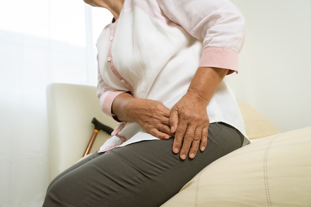 Hip pain of senior woman at home