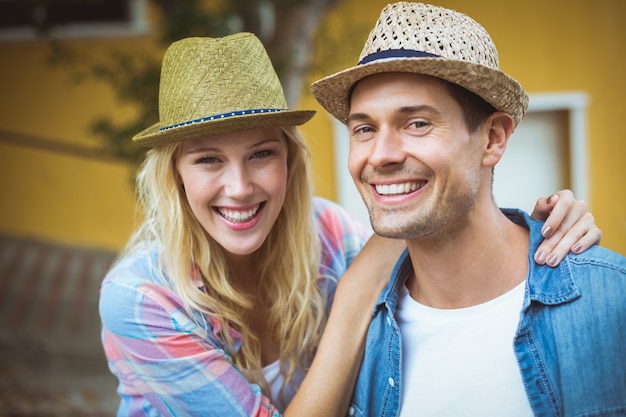 Hip young couple smiling at camera