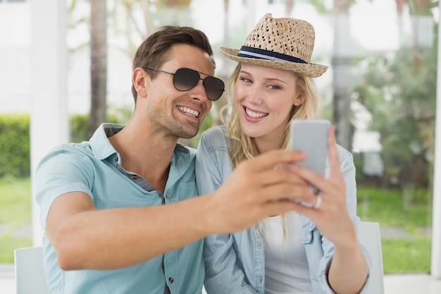 Hip young couple taking a selfie together