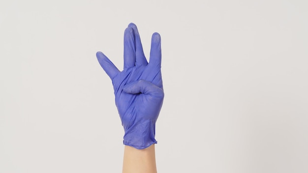 Hiphop west coast hand sign and hand wear violet or purple latex glove on white background