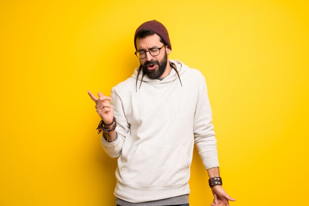 Hippie man with dreadlocks enjoy dancing while listening to music at a party