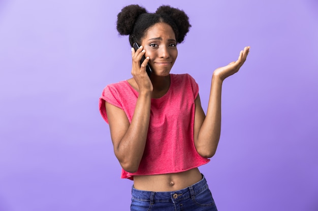 Hipster african american girl smiling and talking on mobile phone, isolated