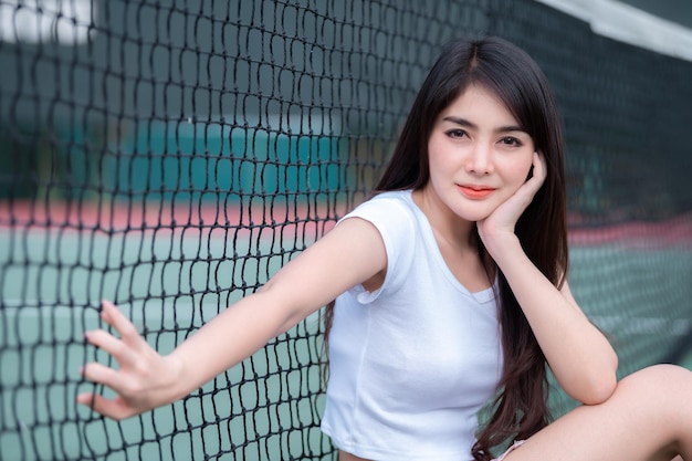 Hipster asian girl pose for take a photoFashion portrait pretty woman at tennis courtlifestyle of modern teenage thai girl