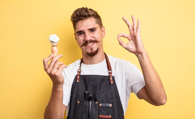 Hipster barber man feeling happy, showing approval with okay gesture