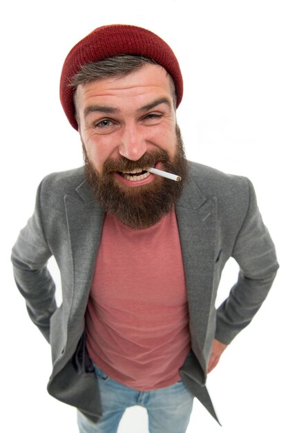 Hipster brutal bearded tobacco smoker Brutality and masculinity Brutal unshaven guy smoking white background close up Man brutal bearded hipster smoking cigarette Brutal habits and lifestyle