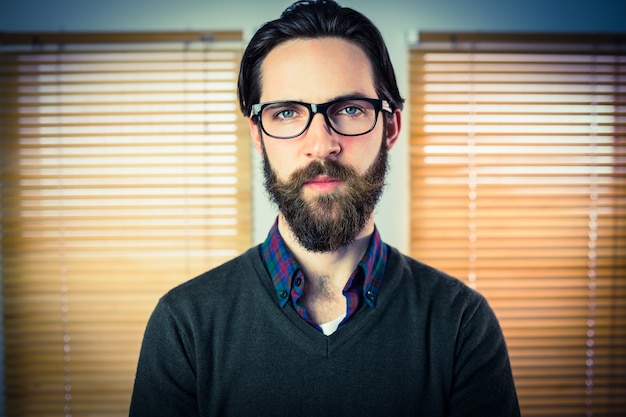 Hipster businessman looking at camera