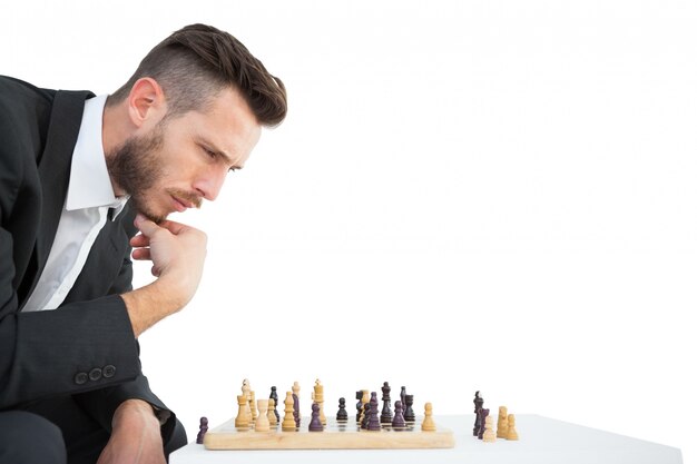 Hipster businessman playing game of chess 