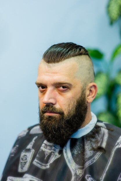 Hipster client visiting barber shop. Mens fashion. Bearded man after barber shop. Man hipster