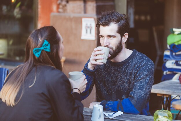 Hipster couple drinking coffee in Stockholm old town. 