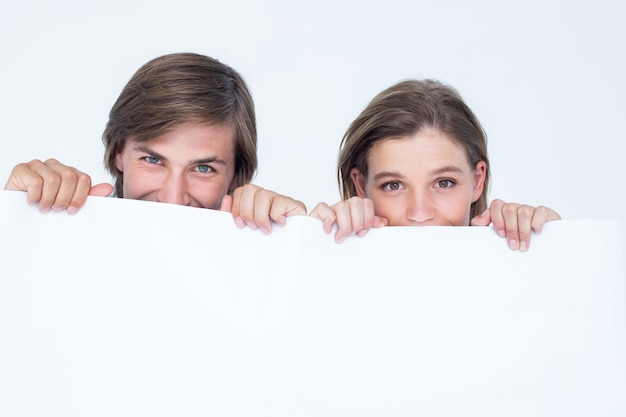 Hipster couple holding poster 