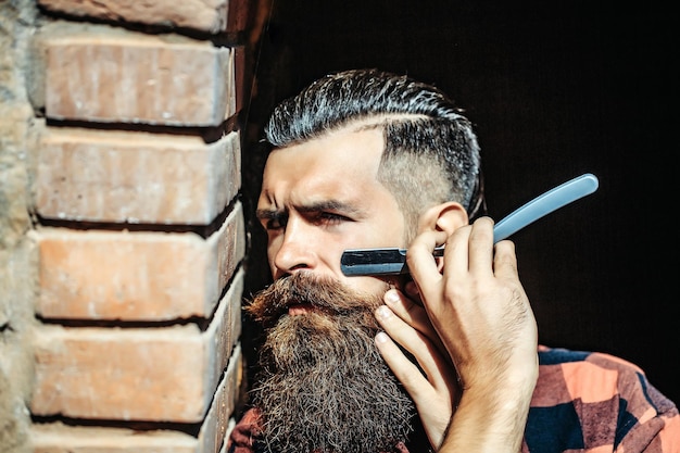 Hipster cutting with razor