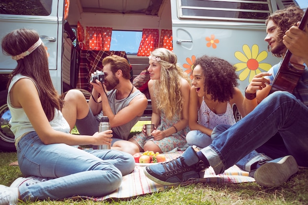 Photo hipster friends by camper van at festival