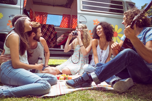 Hipster friends by camper van at festival