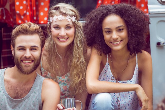 Hipster friends in camper van at festival