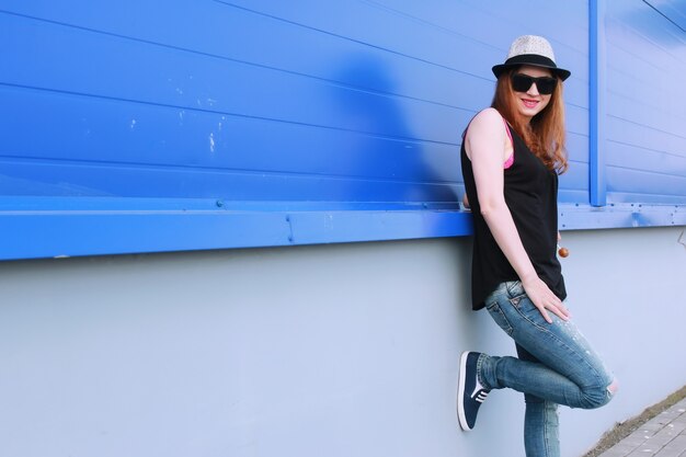 Hipster girl at the blue wall