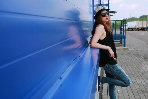 Hipster girl at the blue wall