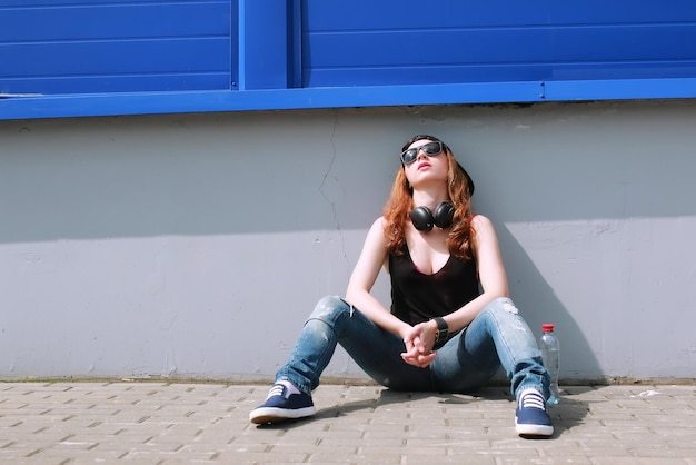 Hipster girl at the blue wall
