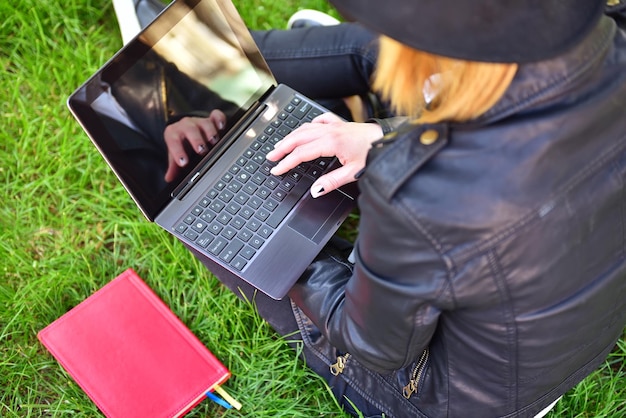 Hipster girl sitting with laptop