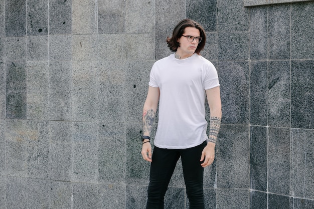 Hipster handsome male model wearing white blank t-shirt 