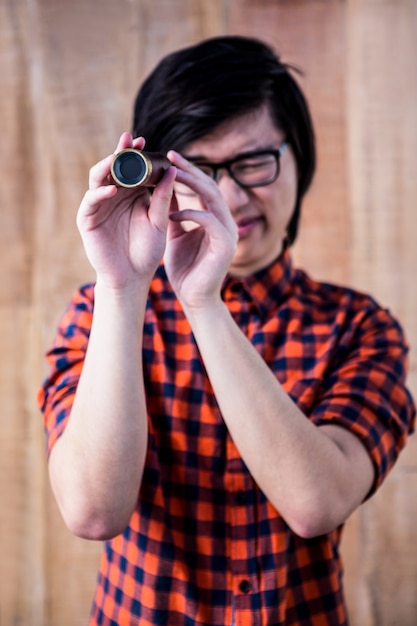 Hipster looking through a telescope