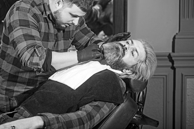 Hipster man sitting in armchair barber shop