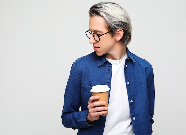 Hipster man standing with takeaway coffee