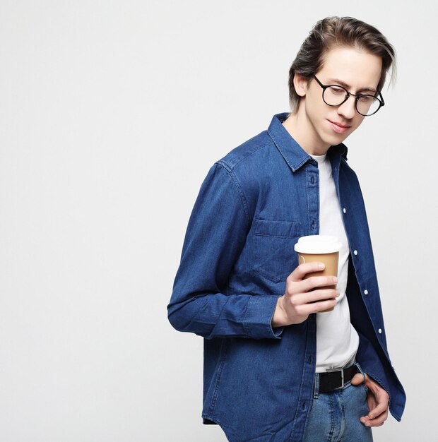 Hipster man standing with takeaway coffee