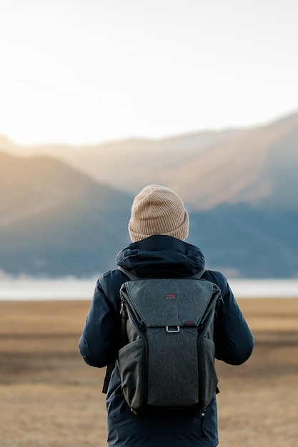 Hipster man traveler with sweater and backpack traveling at Napa Lake