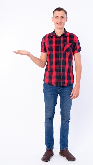 hipster man wearing red checkered shirt isolated against white wall