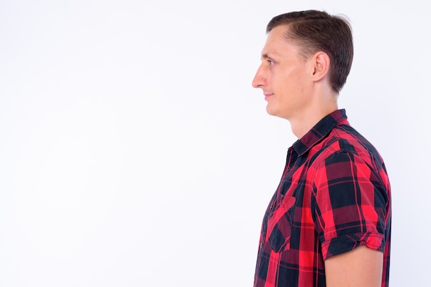 hipster man wearing red checkered shirt isolated against white wall