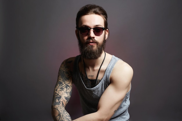 Hipster man with tattoo and sunglasses