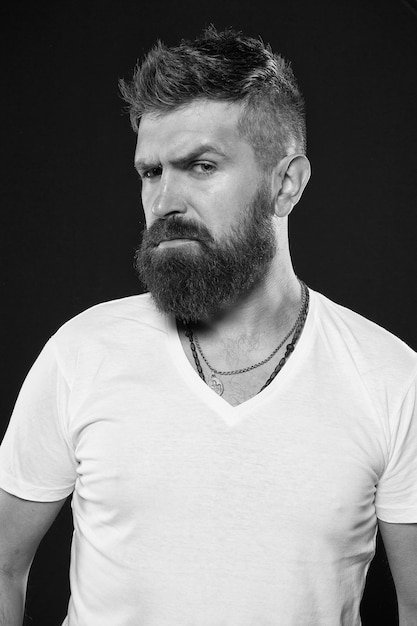 Hipster masculinity Brutal hipster on black background Caucasian hipster with thick beard hair and stylish haircut Bearded man in trendy hipster style