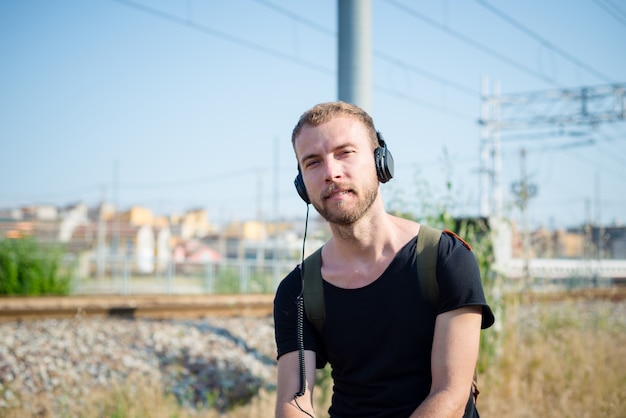 hipster modern stylish blonde man listening music