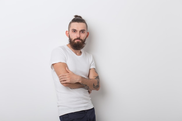 hipster, people concept - hipster guy wearing glasses with arms crossed on a white space