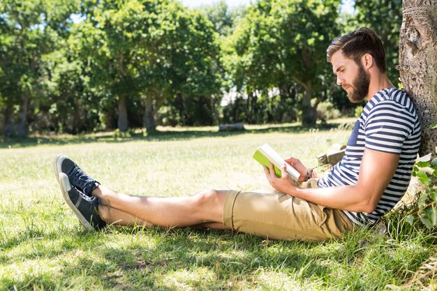 Hipster reading a book in the park