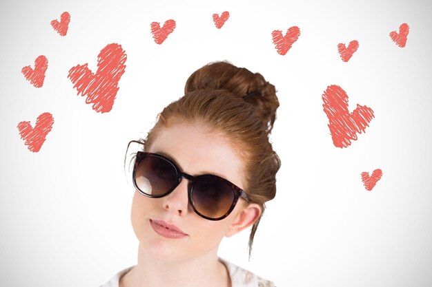 Photo hipster redhead wearing large sunglasses against white background with vignette