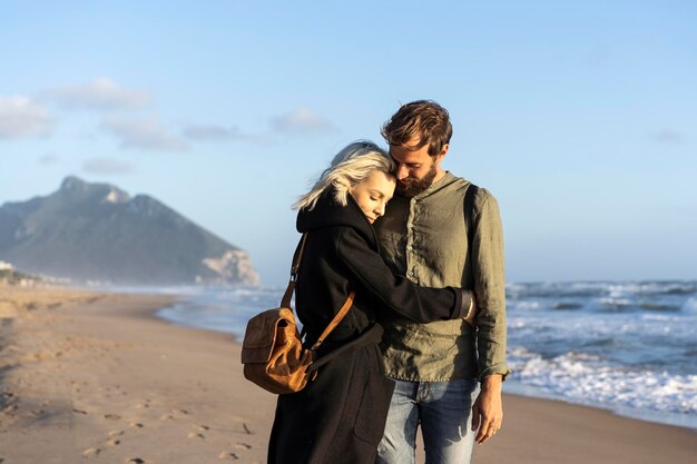 Hipster romantisch paar verliefd elkaar knuffelen op de kustlijn op het wilde strand Vriend en vriendin voor de zee tijdens een sentimentele knuffel Liefdesmomenten