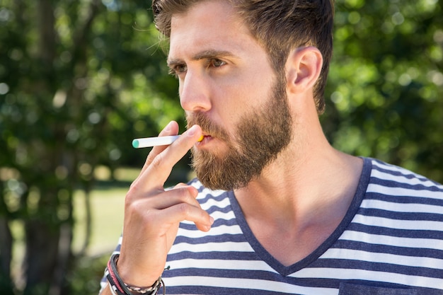 Hipster smoking electronic cigarette