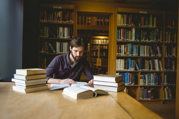 Hipster student studying in library