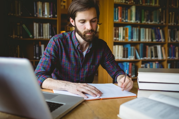 Hipster student studying in library