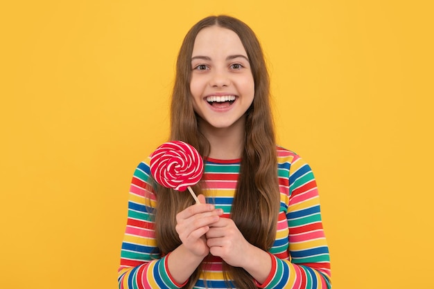 Hipster teenager child girl lick lollypop Sugar nutrition candy and sweets Child eat lollipop popsicle